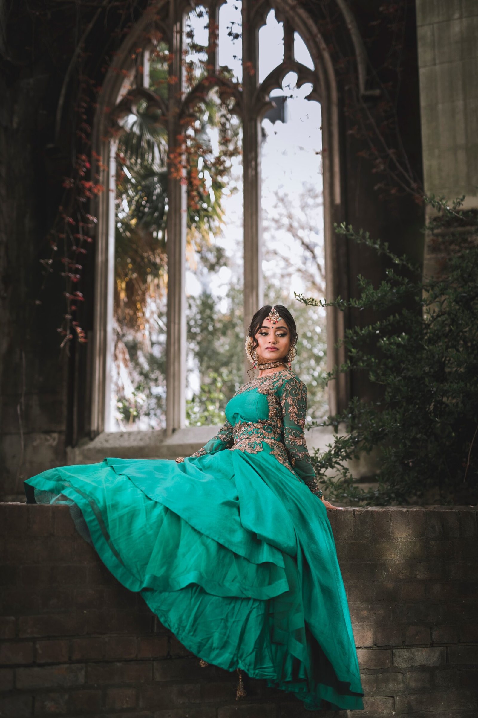 woman in green dress sitting on concrete bench